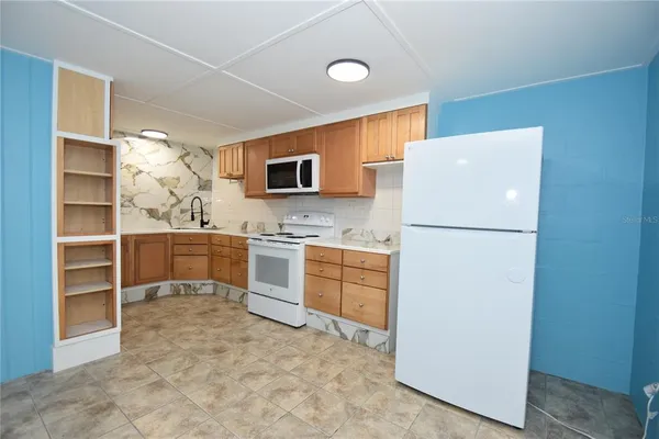 a kitchen with a sink a stove and cabinets