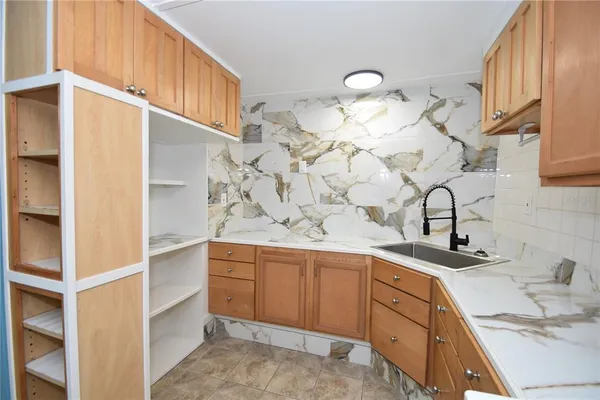 a kitchen with a sink and cabinets