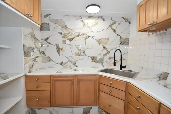 a kitchen with a refrigerator sink and microwave