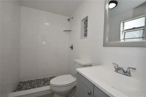 a white toilet sitting next to a bathroom sink
