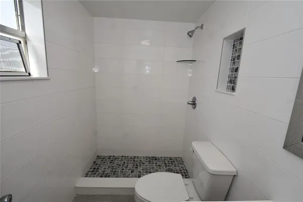 a white toilet sitting next to a bathroom sink