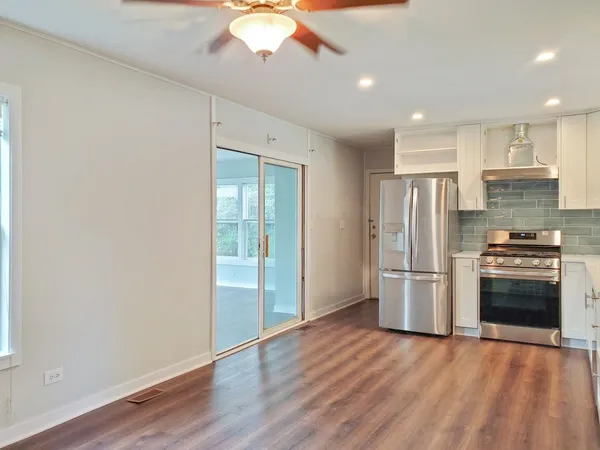 a kitchen with stainless steel appliances a refrigerator and a stove top oven