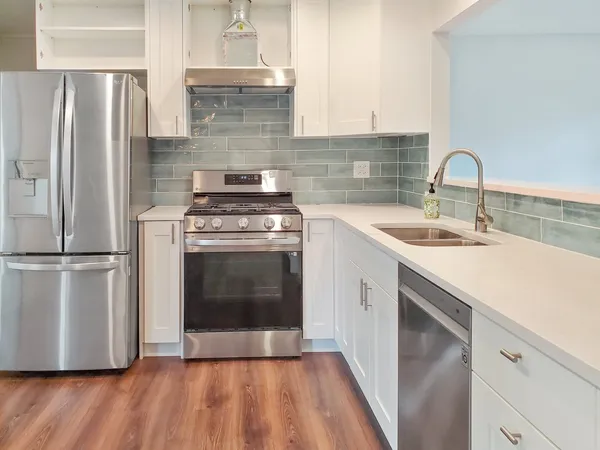 a kitchen with a sink stove and refrigerator