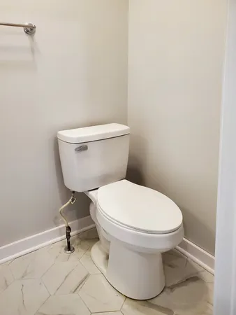 a white toilet sitting next to a white sink