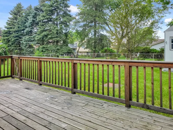 a view of balcony with wooden floor and fence