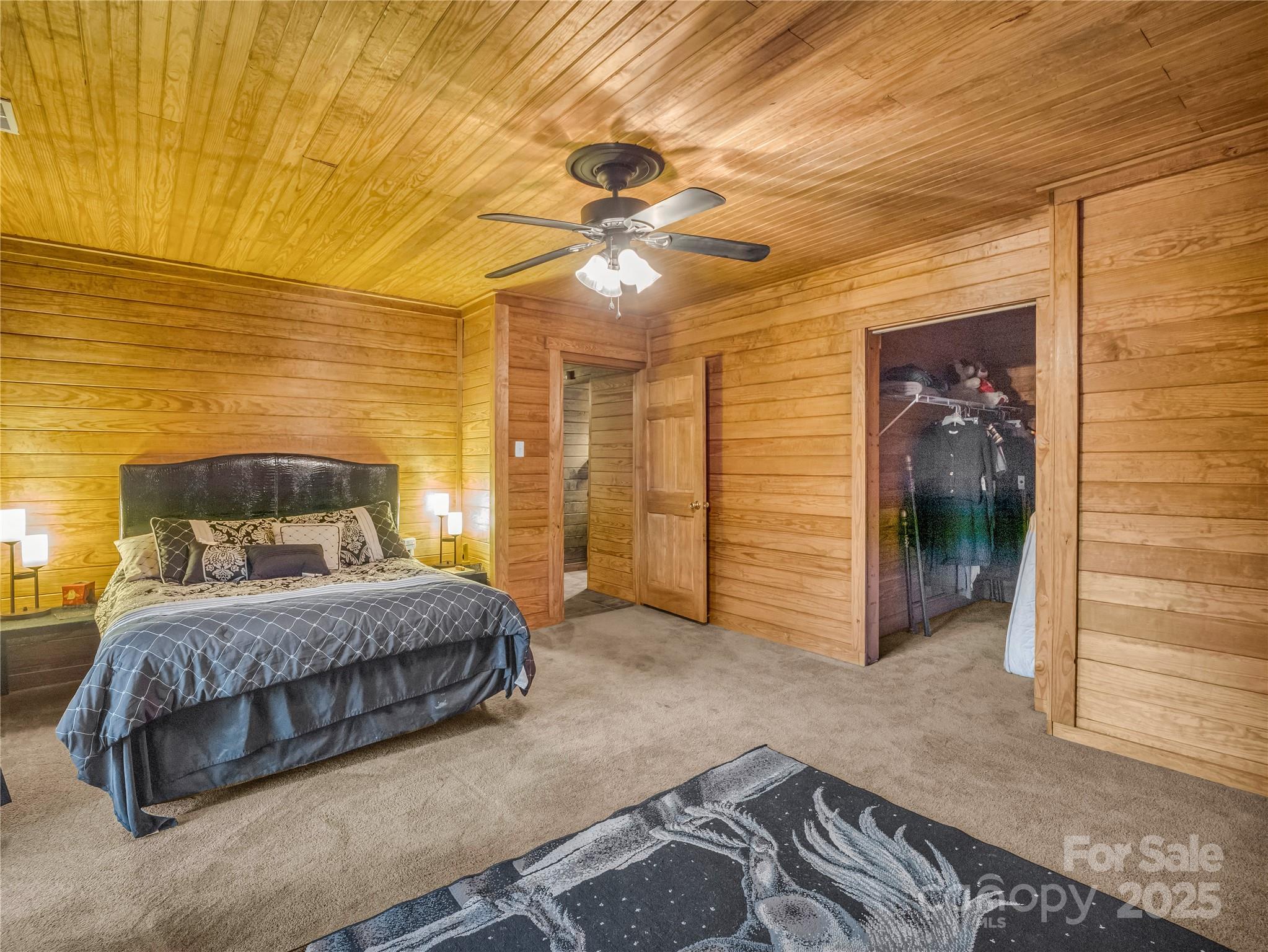 134 Moriah Drive Rutherfordton, NC 28139 - Photo 32 of 37 a spacious bedroom with a bed and a chandelier