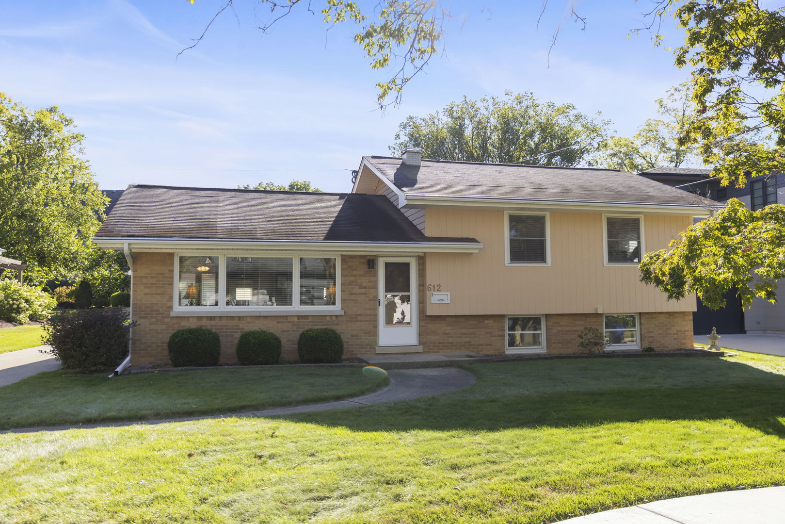 612 Wellner Road Naperville, IL 60540 - Photo 1 of 27 a front view of a house with a yard