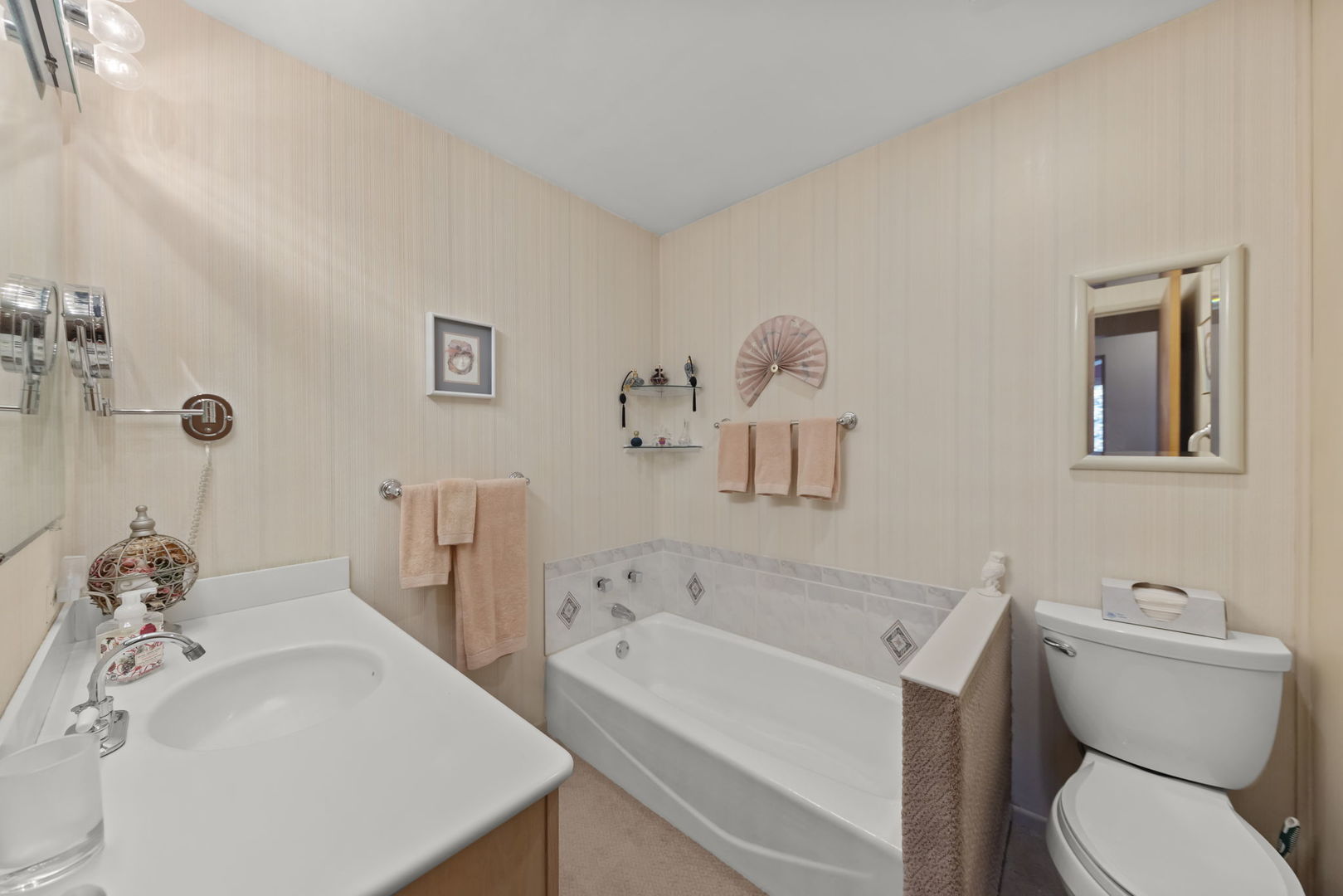 612 Wellner Road Naperville, IL 60540 - Photo 14 of 27 a bathroom with a sink a toilet and bathtub
