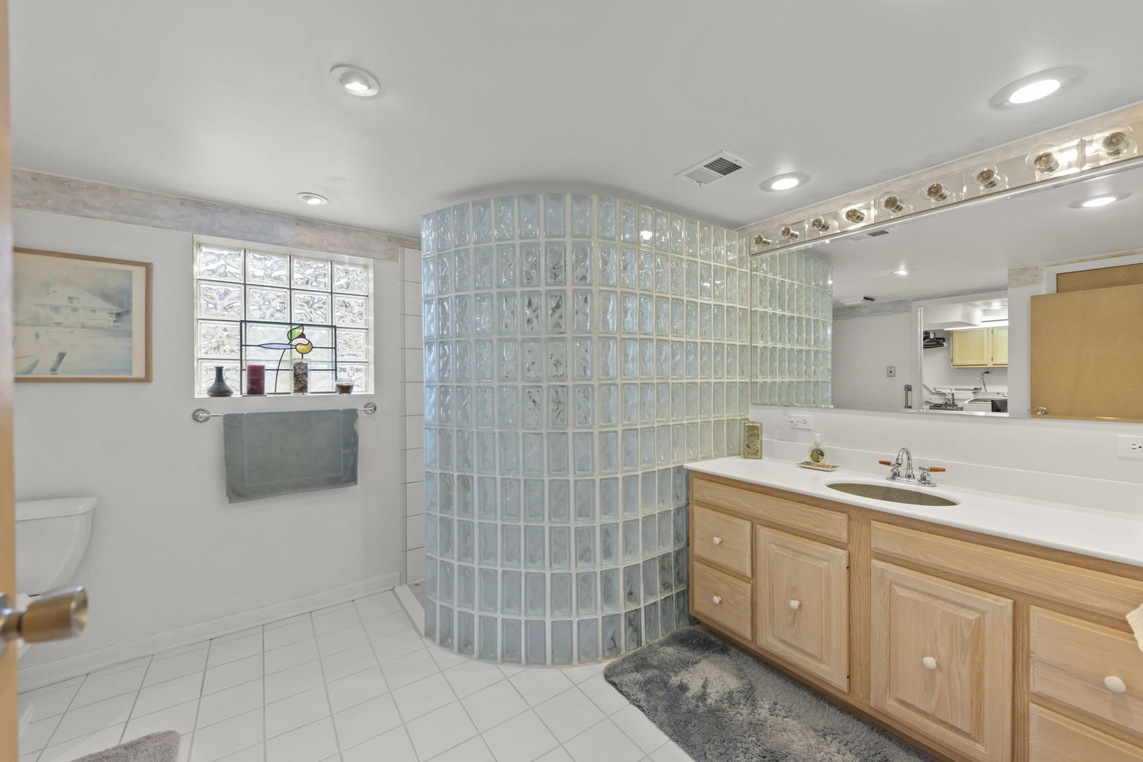 612 Wellner Road Naperville, IL 60540 - Photo 18 of 27 a bathroom with a sink double vanity and a shower
