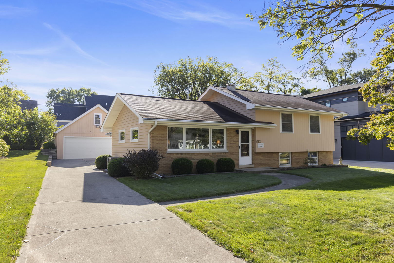 612 Wellner Road Naperville, IL 60540 - Photo 2 of 27 a front view of a house with garden
