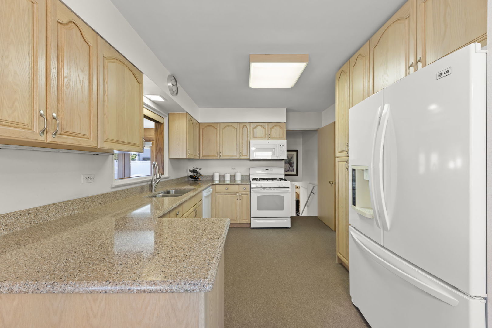 612 Wellner Road Naperville, IL 60540 - Photo 4 of 27 a kitchen with stainless steel appliances granite countertop a refrigerator sink and cabinets