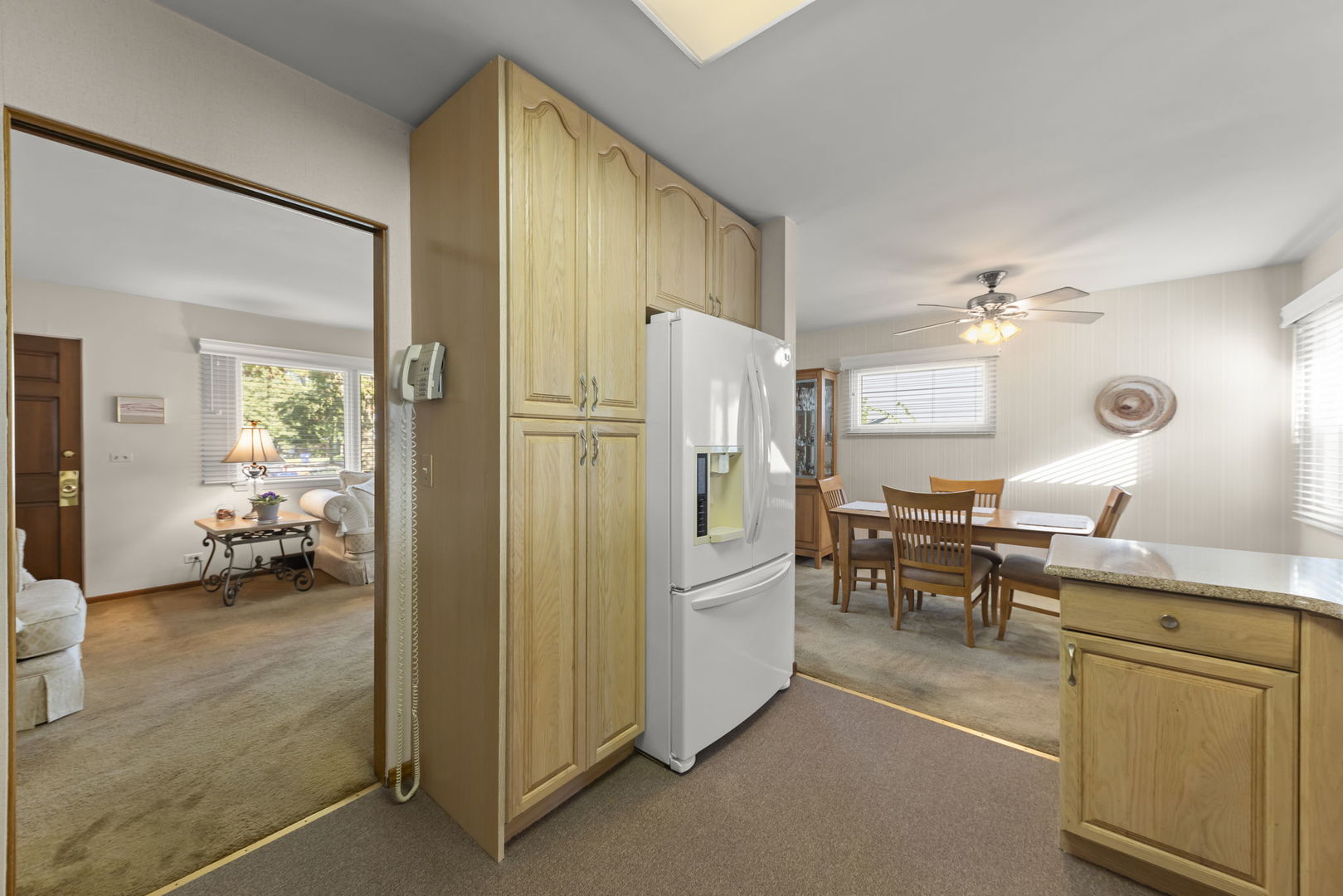 612 Wellner Road Naperville, IL 60540 - Photo 5 of 27 a kitchen with refrigerator and cabinets