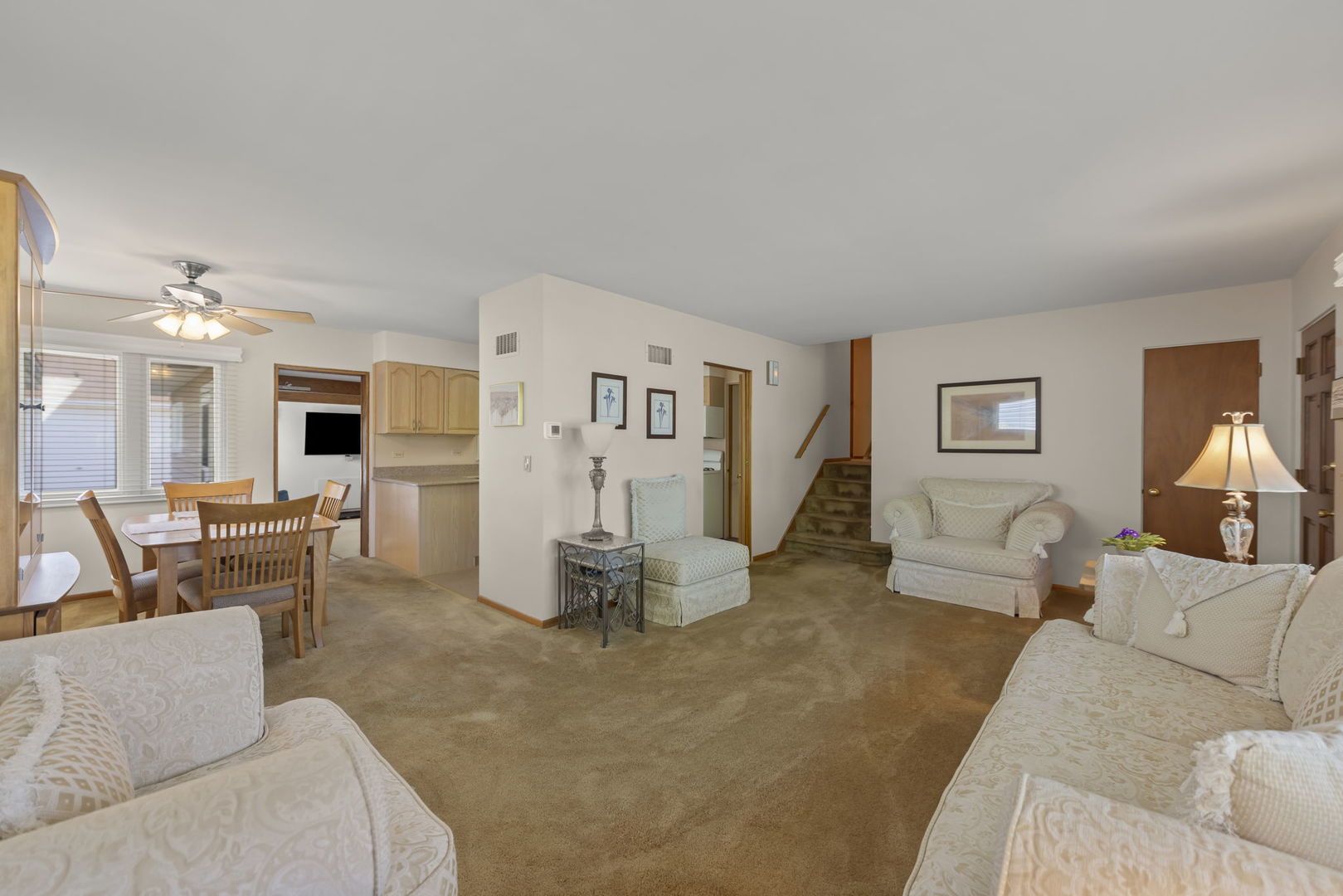 612 Wellner Road Naperville, IL 60540 - Photo 9 of 27 a living room with furniture and a flat screen tv