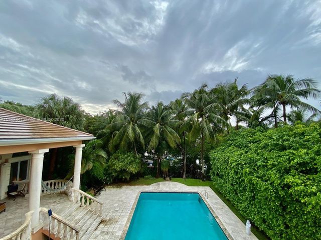 a view of a chair and tables in the balcony