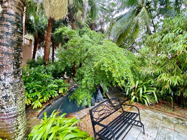 swimming pool view with a seating space and a garden view