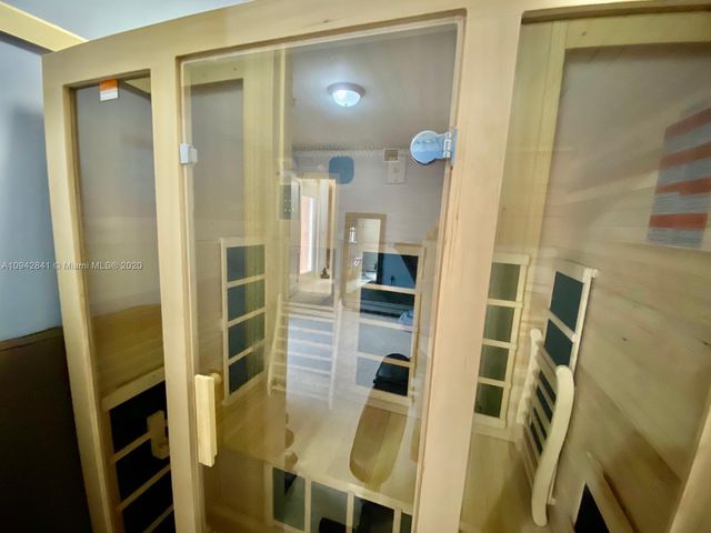 a bathroom with a granite countertop sink toilet a shower and a mirror