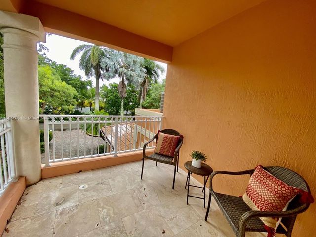 a spacious bedroom with a bed and a flat screen tv