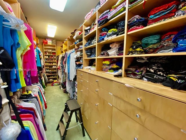 a vase of flowers sitting on a floor in front of a door
