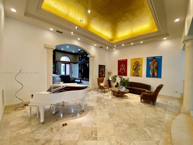 a living room with furniture a projector and a flat screen tv