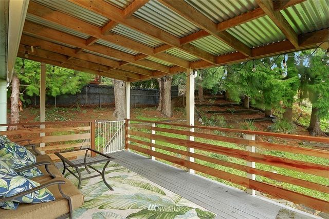 a view of a patio with table and chairs and wooden floor