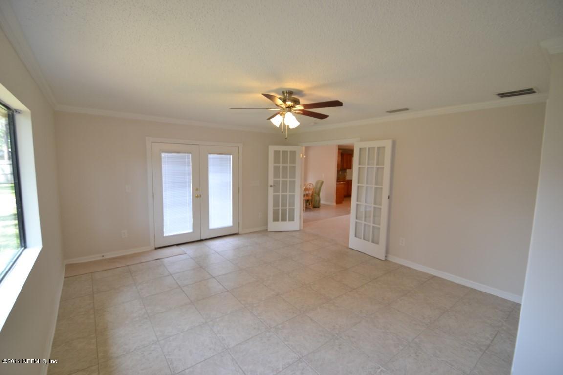 10950 Reading Road Jacksonville, FL 32257 - Photo 18 of 42 an empty room with chandelier fan and windows
