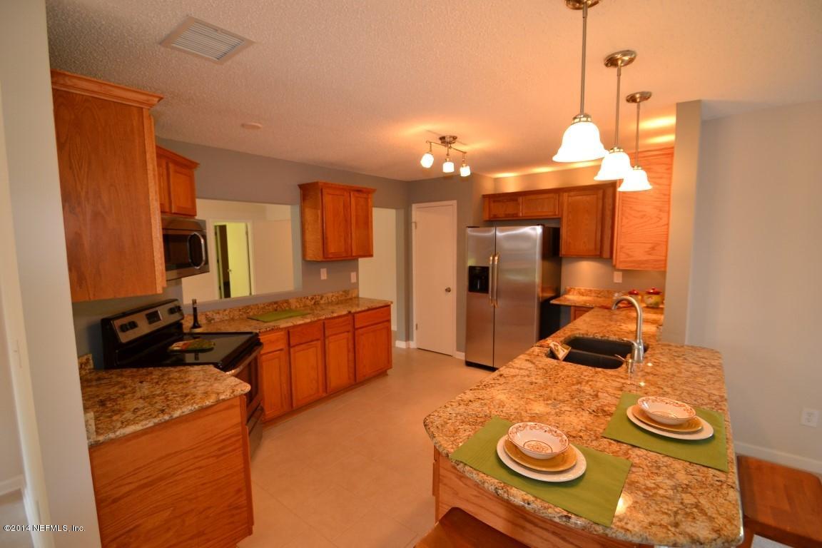 10950 Reading Road Jacksonville, FL 32257 - Photo 2 of 42 a large kitchen with a stove and a refrigerator