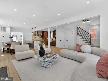 a living room with furniture and a chandelier