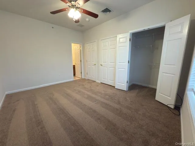 a view of a livingroom with a ceiling fan and window