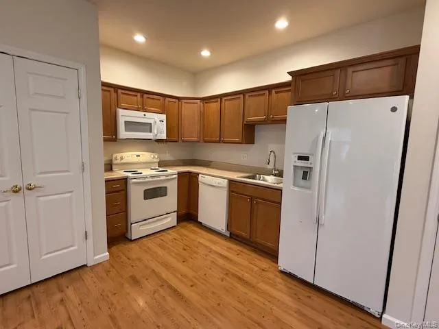 a kitchen with stainless steel appliances a refrigerator sink and microwave