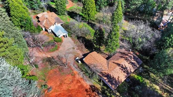 an aerial view of a house with a yard
