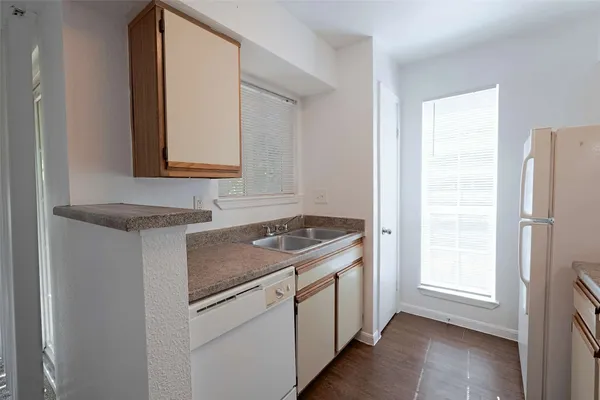a kitchen with a stove cabinets and a refrigerator