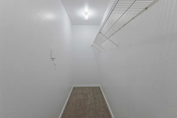 a view of a hallway with racks on the wall