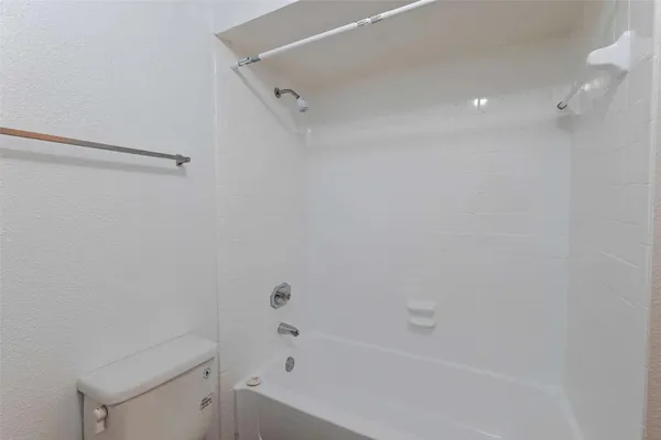 a bathroom with a bathtub and toilet