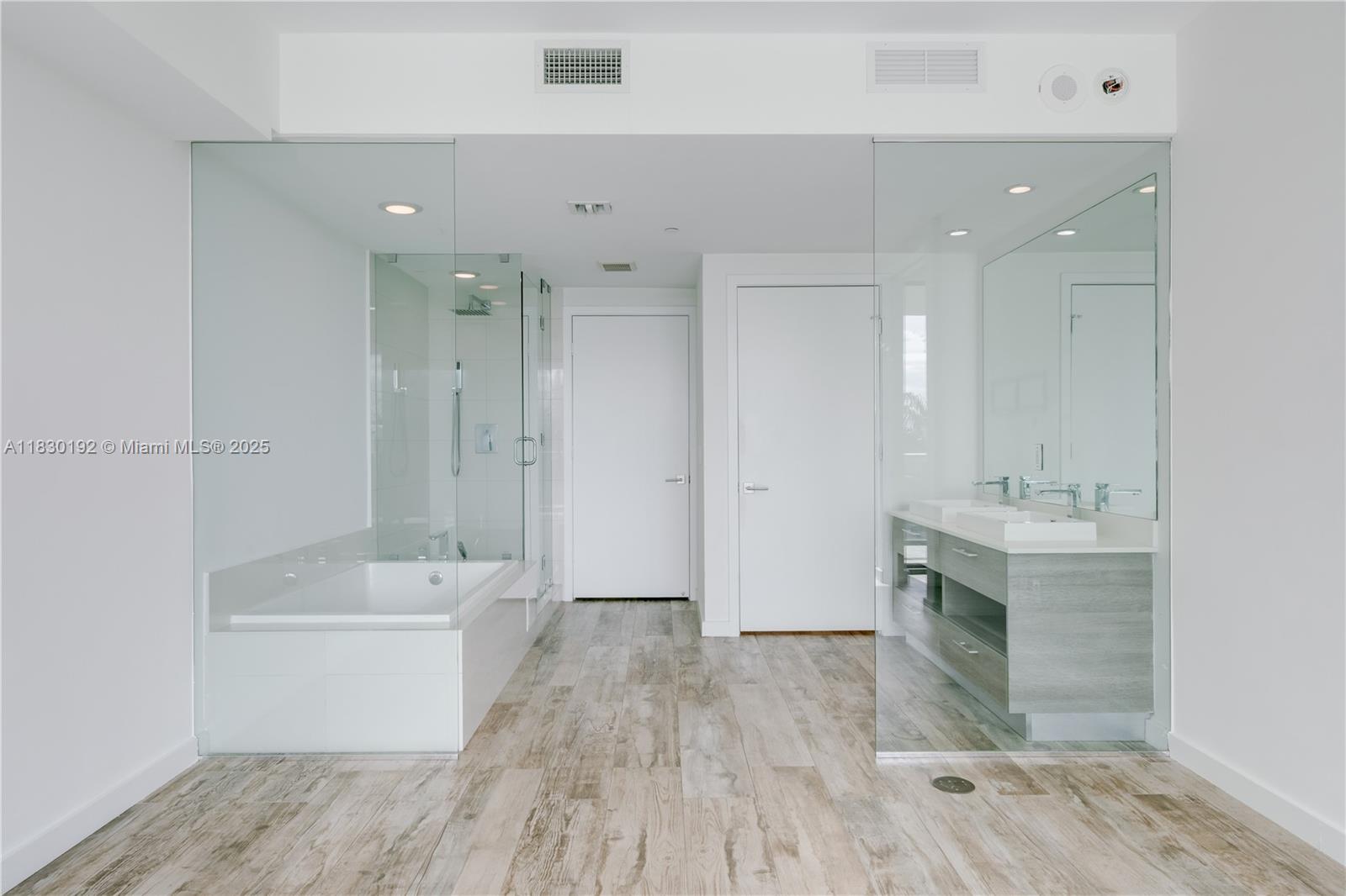 650 Northeast 32nd Street, Unit 802 Miami, FL 33137 - Photo 14 of 33 a bathroom with a sink a mirror and a bathtub