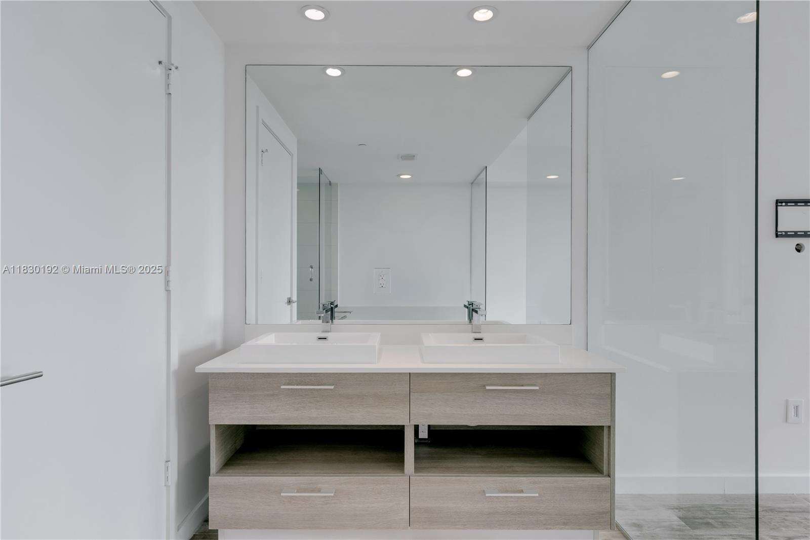 650 Northeast 32nd Street, Unit 802 Miami, FL 33137 - Photo 18 of 33 a bathroom with a sink a mirror and a bathtub