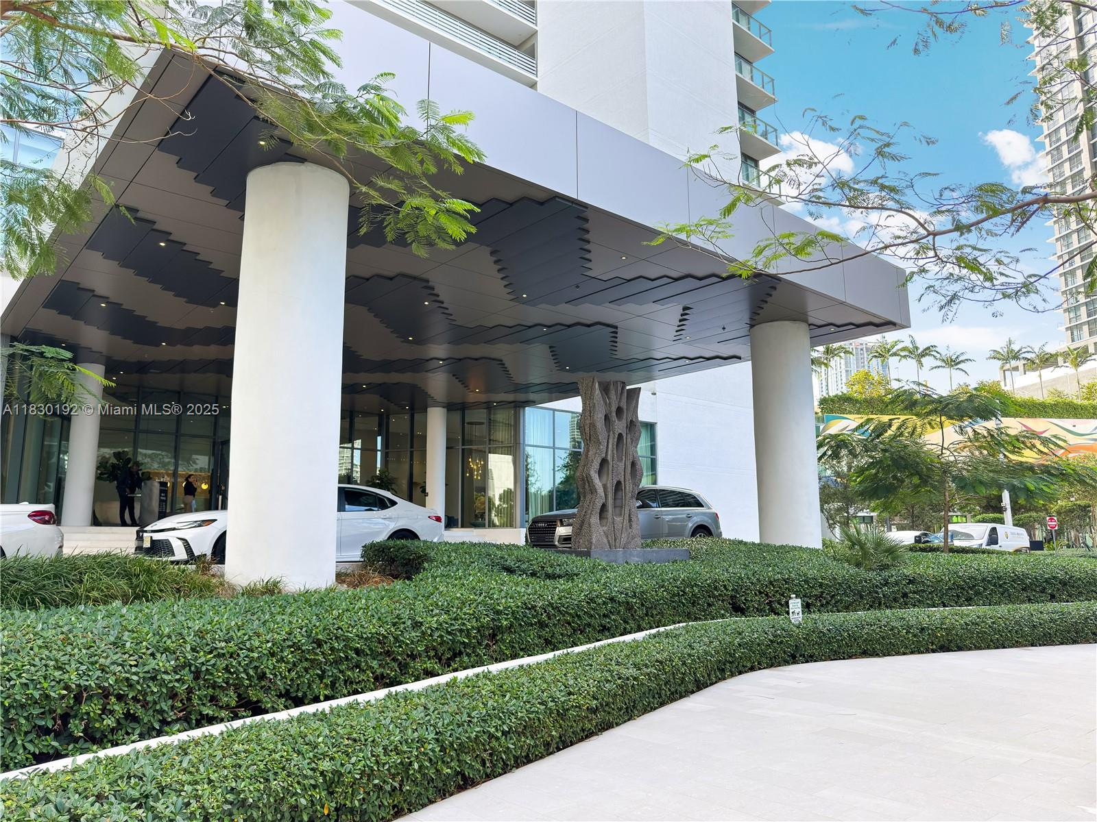 650 Northeast 32nd Street, Unit 802 Miami, FL 33137 - Photo 2 of 33 a front view of a house with a yard