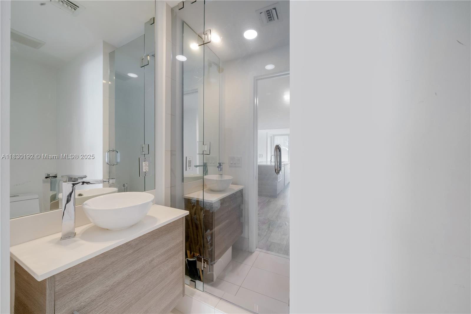 650 Northeast 32nd Street, Unit 802 Miami, FL 33137 - Photo 23 of 33 a bathroom with a sink and a mirror