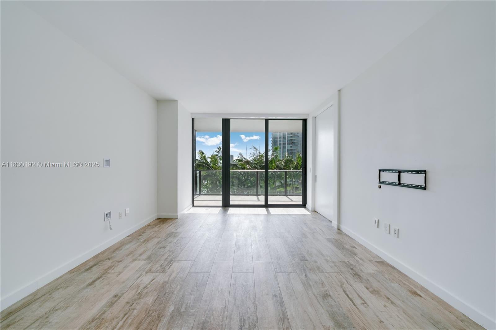 650 Northeast 32nd Street, Unit 802 Miami, FL 33137 - Photo 5 of 33 wooden floor in an empty room with a window