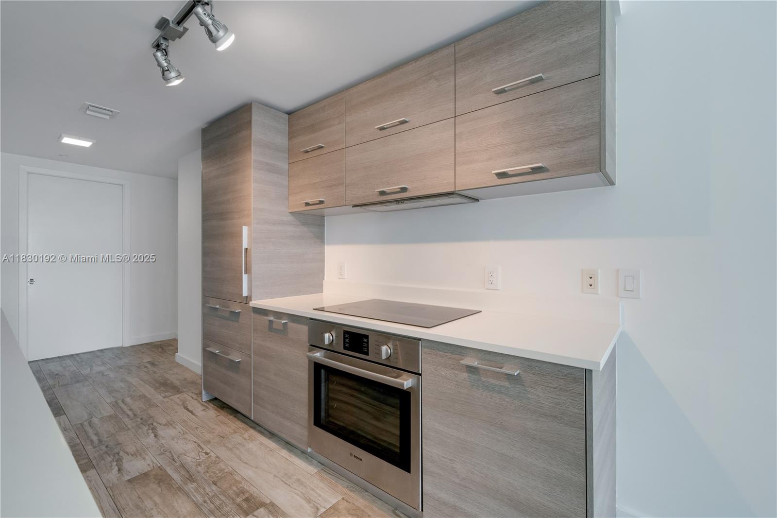 650 Northeast 32nd Street, Unit 802 Miami, FL 33137 - Photo 7 of 33 a kitchen with stainless steel appliances granite countertop a stove and a microwave
