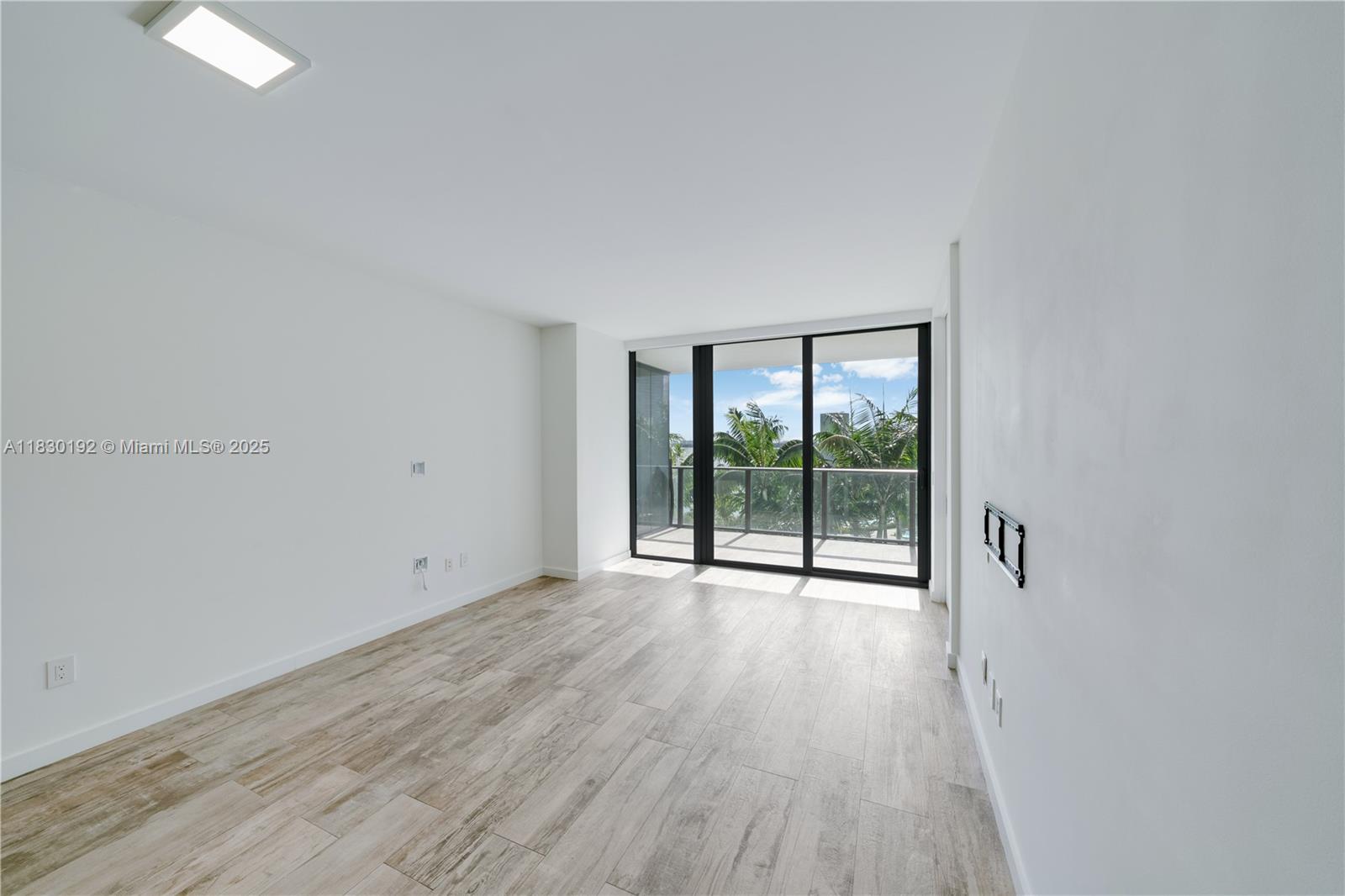 650 Northeast 32nd Street, Unit 802 Miami, FL 33137 - Photo 10 of 33 wooden floor in an empty room with a window