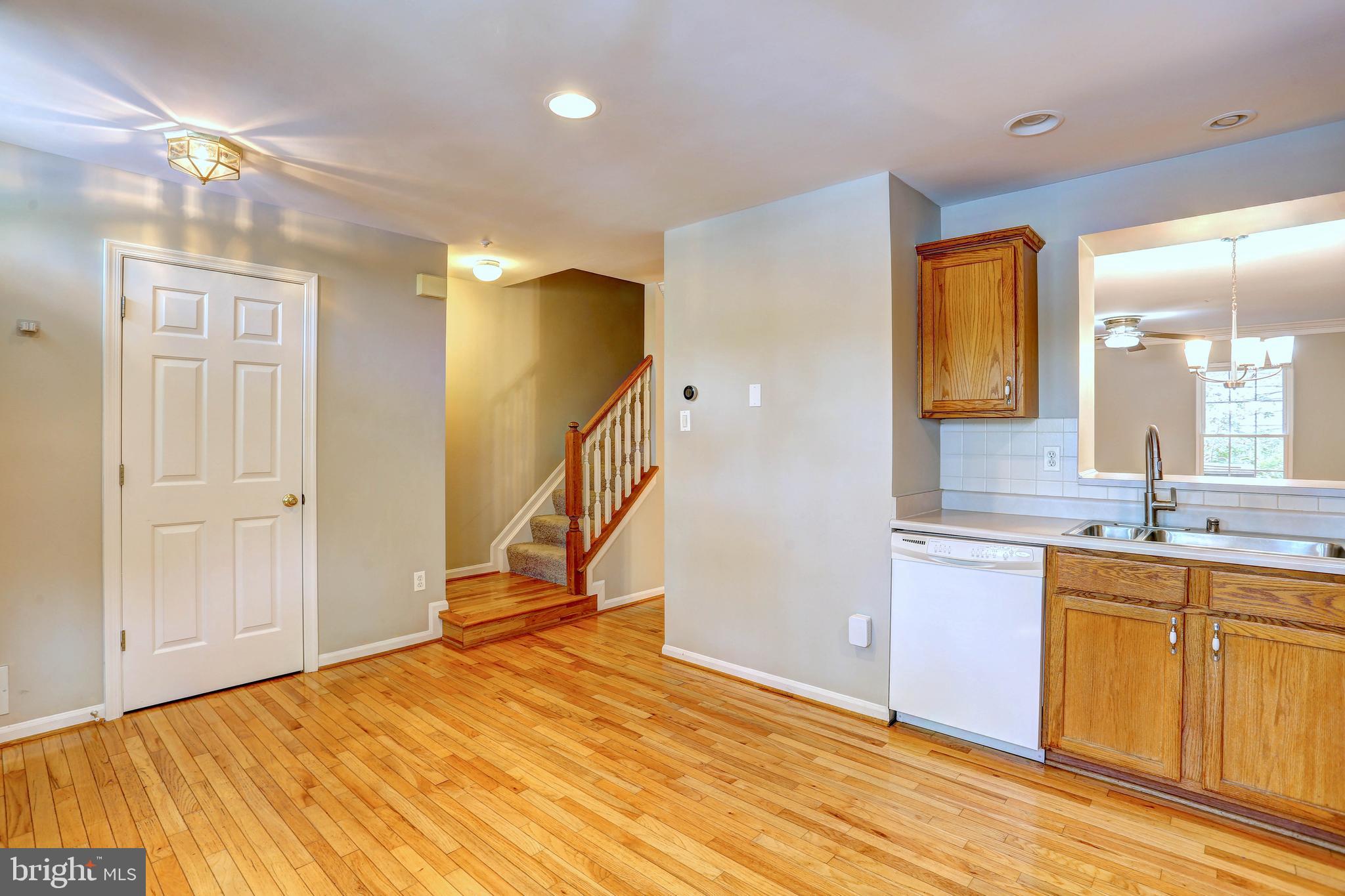 6136 Starburn Path Columbia, MD 21045 - Photo 5 of 35 a view of a kitchen with a sink and a wooden cabinet