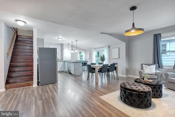 a dining room with furniture and wooden floor