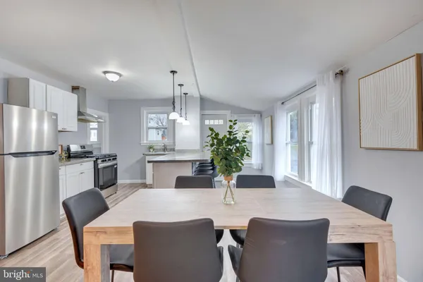 a kitchen with a table and chairs in it