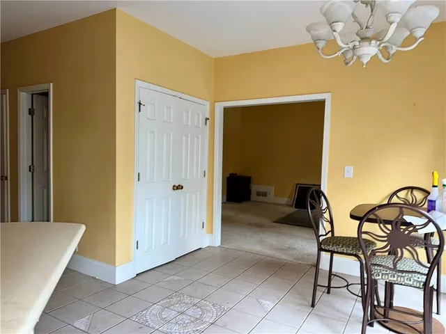 a view of a livingroom with furniture and chandelier