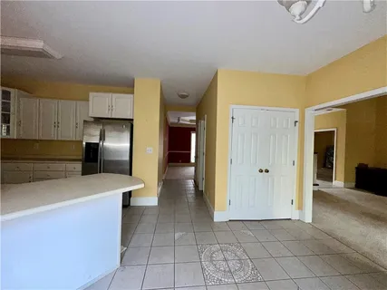 a kitchen with stainless steel appliances a refrigerator sink and cabinets