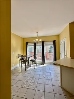 a view of a dining room with furniture and chandelier