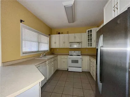 a kitchen with a sink appliances and cabinets