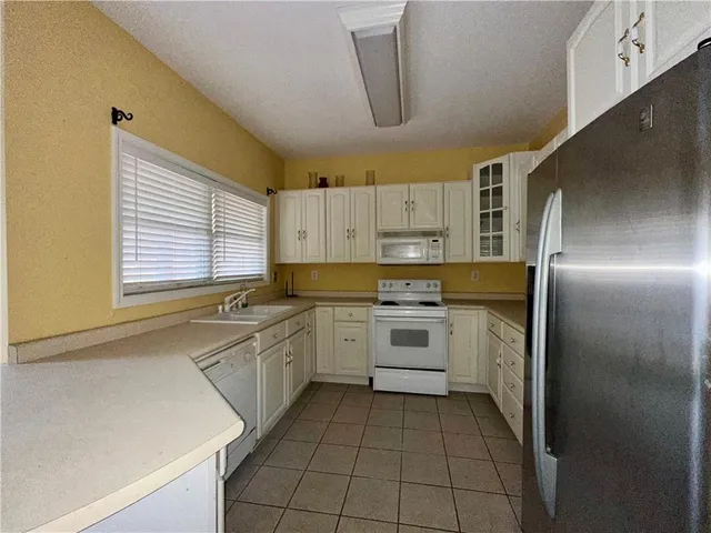 a kitchen with a sink appliances and cabinets