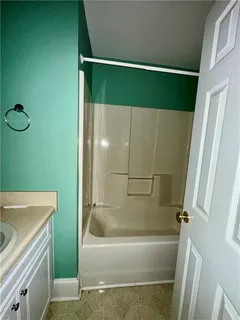 a bathroom with a tub and a shower