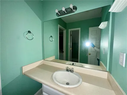 a bathroom with a sink and a mirror